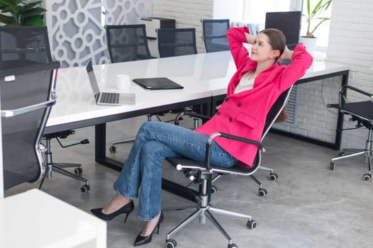 Caucasian woman relaxing while sitting at her desk