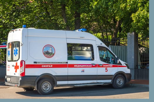 Vyborg, Leningradskaya region, Russia - 08.25.2024. Ambulance vehicle parked on the street ready for emergency medical response. Side view of the ambulance showing medical symbols, emergency signage