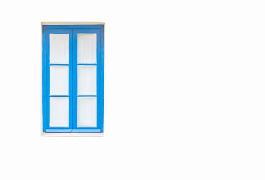 White wall with a turquoise window and white curtains behind it.