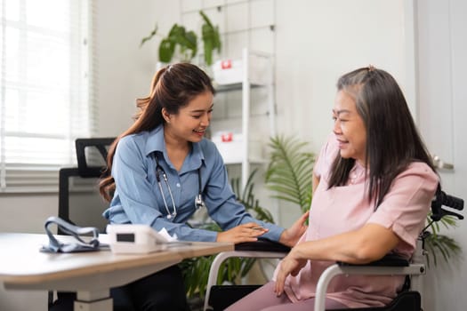 A dedicated nurse interacts with an elderly woman in a comforting home setting, ensuring she feels cared for and understood during her medical checkup.