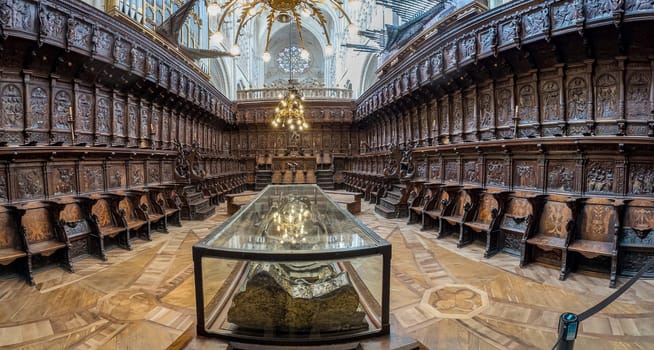 A stunning view of intricately carved wooden choir stalls, highlighting detailed craftsmanship and historical architecture in a cathedral.
