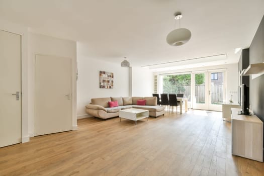 Contemporary living room featuring a cozy couch, sleek furniture, and a design that combines functionality with aesthetic appeal for an inviting atmosphere.