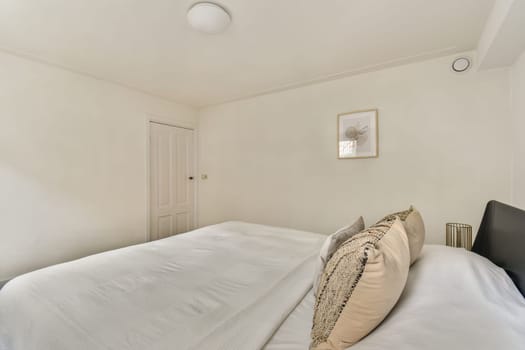 This serene bedroom features a minimalist design, a comfortable bed, and stylish decor elements, creating a peaceful space for relaxation and unwinding.