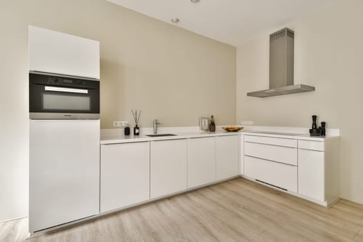 Sleek and contemporary kitchen featuring white cabinets, stainless steel appliances, and a clean layout that enhances functionality and aesthetics.