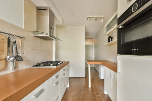 A sleek and modern kitchen featuring minimalist cabinetry, wooden countertops, and contemporary appliances that create an inviting cooking space.