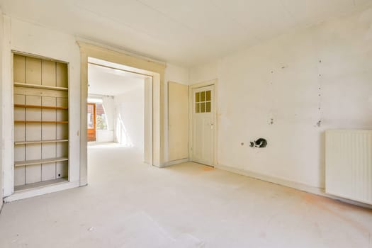 An empty room showcasing natural light flowing through windows, highlighting a minimalist interior. Clean walls and simple structures create a tranquil atmosphere.