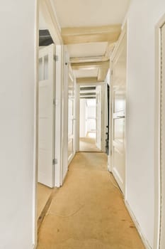 A spacious interior hallway featuring multiple doors, light-colored walls, and a neutral carpet that enhances the open feel of the space.