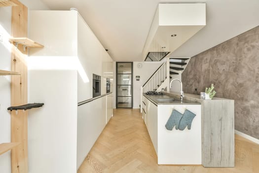A stylish and modern kitchen featuring sleek white cabinets, a minimalist design, and contemporary decor elements that enhance the space's functionality and aesthetic appeal.