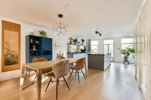 A stylish and inviting dining space featuring contemporary furniture, natural light, and green plants, perfect for gatherings and family meals.