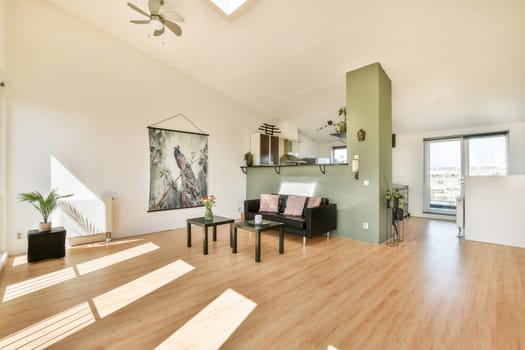 A spacious modern interior showcasing natural light, minimalistic furniture, and elegant decor. The room features neutral colors and a touch of greenery for a cozy ambiance.