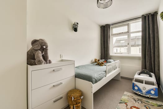 A bright and cozy children's bedroom featuring a bed, playful decor, and soft furnishings, perfect for creating a warm atmosphere for kids.