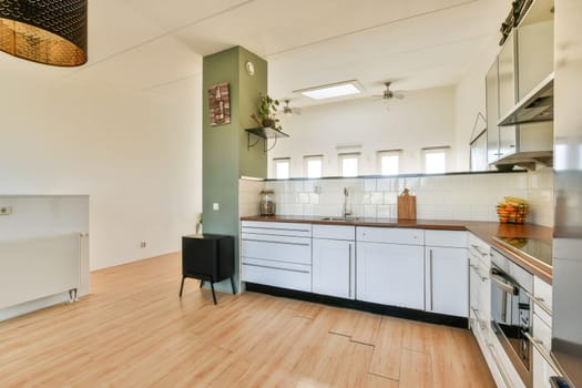 Bright and airy modern kitchen featuring a sleek design with wooden accents, ample storage, and contemporary appliances for a functional cooking space.