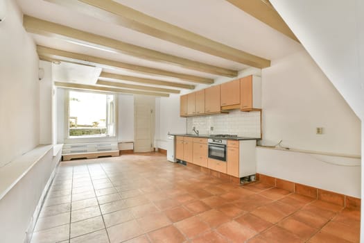A spacious modern kitchen showcasing sleek cabinetry and ample natural light, emphasizing minimalistic design and functionality.