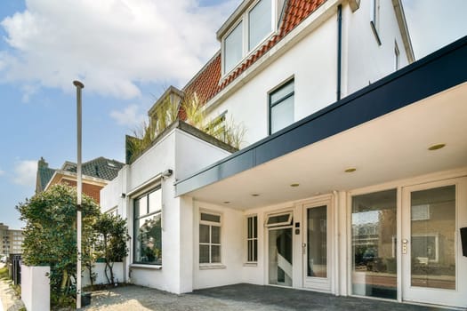 Contemporary architecture featuring a stylish facade and landscaped surroundings in a vibrant urban setting, showcasing modern living spaces.