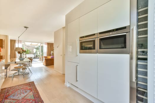 A sleek modern kitchen featuring built-in appliances, minimalist cabinetry, and an open layout connecting to the living space, perfect for entertaining guests.