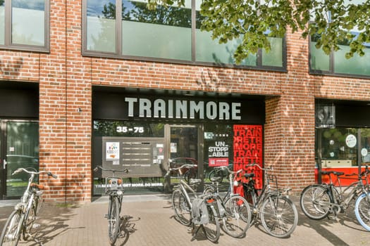 A stylish urban shop featuring a brick facade and large glass windows, bicycles parked outside, showcasing a vibrant city atmosphere.
