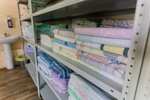 Sanitary prevention antivirus concept. Fresh White Hotel Towels Folded and Stacked on Shelf
