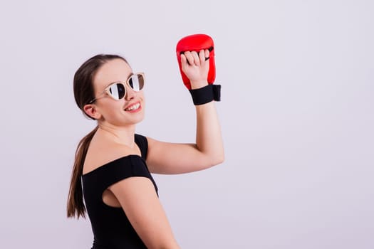 Studio portrait of a boxer female in bodysuit with gloves red