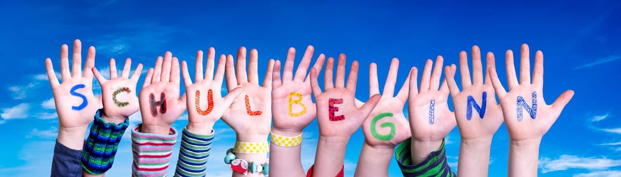 Children Hands Building Colorful German Word Schulbeginn Means First Day Of School. Blue Sky As Background.