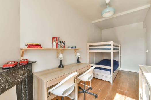 A bright and airy children's room featuring a bunk bed, minimalist furniture, and a cozy atmosphere that promotes a playful yet relaxing environment.