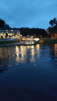 October 17 2024 Bad Schandau Germany Europe Nighttime river boat lake night light water landscape background summer travel tourism transport shotlisttravel outdoor . High quality photo