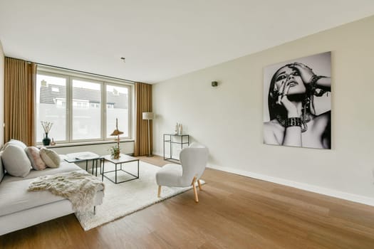 A stylish modern living room featuring a chic sofa, elegant decor, and an eye-catching wall art piece, creating a cozy and inviting atmosphere.