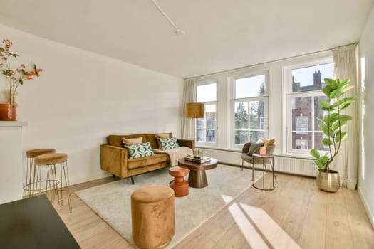 A beautifully arranged living room featuring a stylish sofa, vibrant decor, and large windows offering natural light. Perfect for modern interior inspiration.