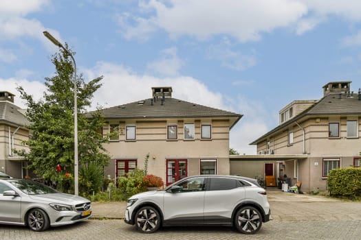 A peaceful residential neighborhood featuring stylish homes and contemporary cars parked in driveways, enhancing the suburban charm and landscape.