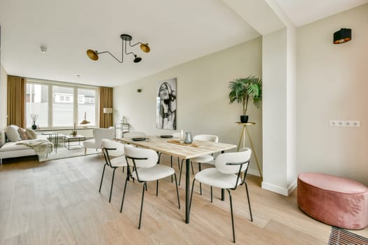A stylish modern living room featuring elegant furnishings, ample natural light, and a serene color palette that creates a welcoming atmosphere.