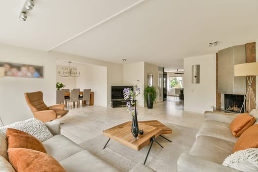 Spacious and stylish living room featuring contemporary furniture, elegant decor, and a warm atmosphere, perfect for relaxation and social gatherings.