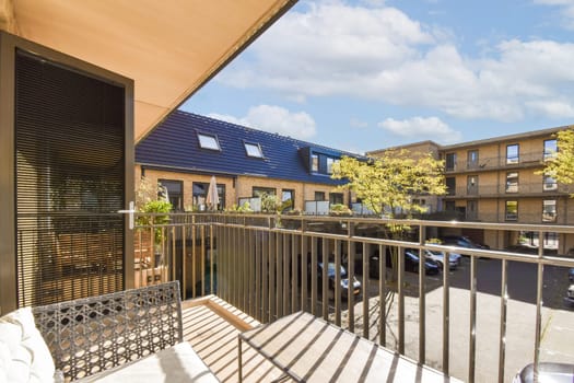 A stylish balcony featuring a blend of modern design, greenery, and a clear blue sky. Perfect for relaxation and enjoying the outdoor ambiance.