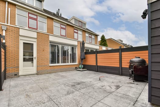Spacious modern patio showcasing brick architecture and outdoor furnishings. The design features a mix of functionality and contemporary aesthetics.