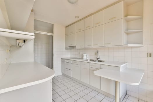 A spacious and sleek modern kitchen featuring white cabinetry, minimalist design, and clean lines, beautifully arranged for functionality and style.