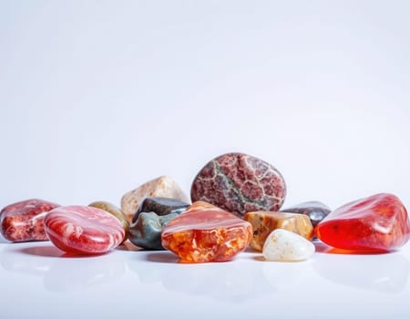 Collection of colorful rocks and gemstones on a reflective surface