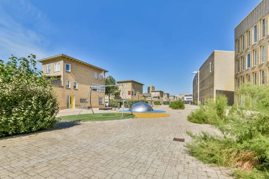 A view showcasing modern buildings alongside lush greenery, creating a vibrant urban environment. The scene captures a harmonious blend of architecture and nature.