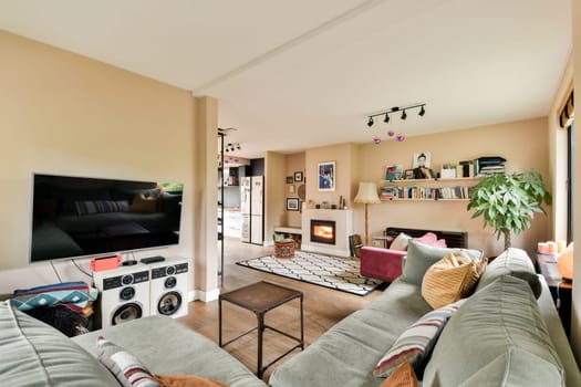 A modern living room featuring a comfortable sofa, stylish decor, and a welcoming ambiance. The space is elegantly designed for relaxation and social gatherings.