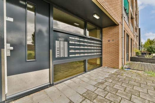 An inviting modern entrance featuring a sleek mailbox setup and contemporary architecture. The scene highlights design and accessibility in urban spaces.