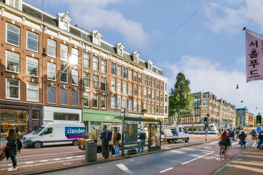 A vibrant city street showcasing historical buildings, quaint shops, and pedestrians enjoying the sunny day, creating a lively urban atmosphere.