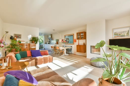 A beautifully designed modern living room featuring vibrant decor, comfortable seating, and ample natural light, creating a warm and inviting atmosphere for relaxation.