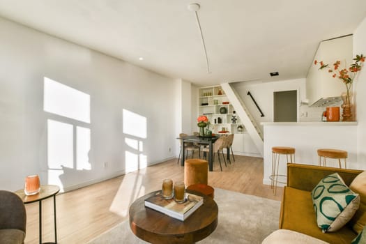 A stylish modern living room featuring minimalist design, natural light, and contemporary furniture enhances comfort and aesthetics.
