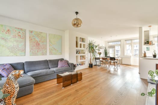 A contemporary living room showcasing elegant furniture, vibrant artwork on the walls, and tasteful decor elements that enhance its inviting ambiance.