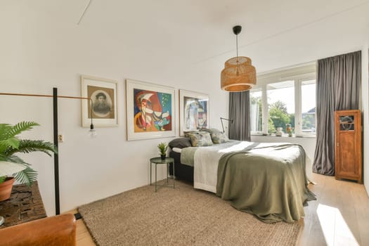 A bright bedroom featuring a stylish bed, vibrant artwork on the walls, and a touch of greenery, creating a cozy and inviting atmosphere.