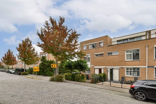 A contemporary residential neighborhood characterized by modern architecture, scenic trees, and a gently curving street that invites exploration.