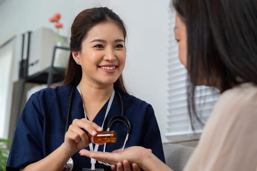 A caregiver engages warmly with an elderly woman, ensuring she understands her medication options with a friendly approach.