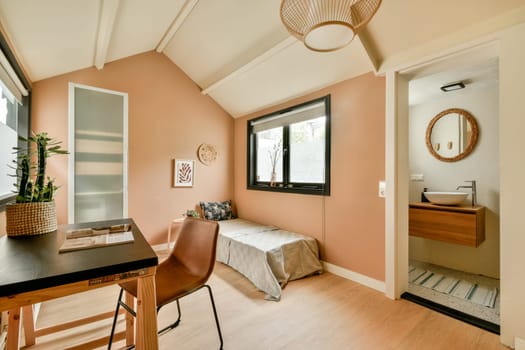 A beautifully designed interior showcasing modern furniture and warm colors, enhanced by natural light, creating an inviting workspace and relaxation area.