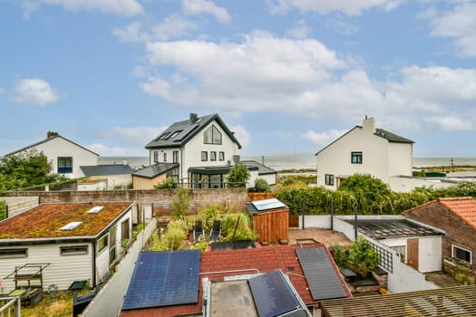 A picturesque view of charming suburban houses nestled among vibrant gardens and greenery, reflecting a cozy residential atmosphere.
