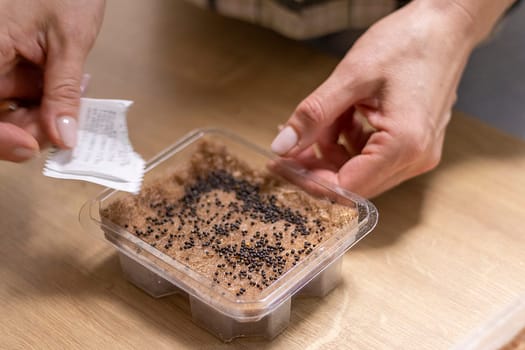 Person plants seeds of micro greens to the jute mat.