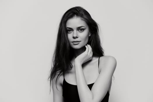 A stunning black and white portrait showcasing a young woman's serene expression, highlighting her beauty and confidence, perfect for beauty and fashion concepts.