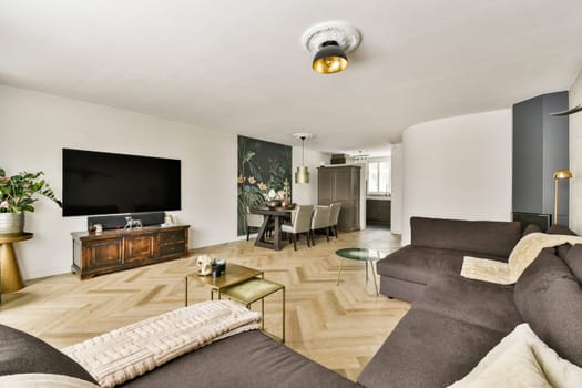Stylish modern living room featuring a neutral color palette, elegant furniture, and a decorative wall. Perfect for contemporary home aesthetics.