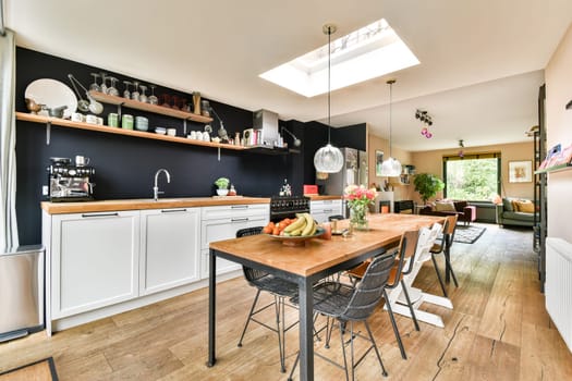 A stylish modern kitchen featuring an open layout, wooden countertops, and contemporary decor. The space blends functionality with a relaxed atmosphere.